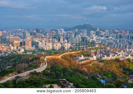 Aerial view of Seoul downtown cityscape and Namsan Seoul Tower on sunset from Inwang mountain. Seoul, South Korea.