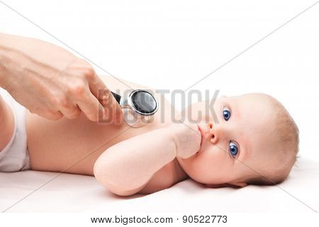 Close-up shot of pediatrician examines three month baby girl. Doctor using a stethoscope to listen to baby's chest checking heart beat. Child is looking at camera sucking hand.