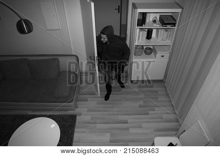 High Angle View Of A Robber Entering In Vacant House