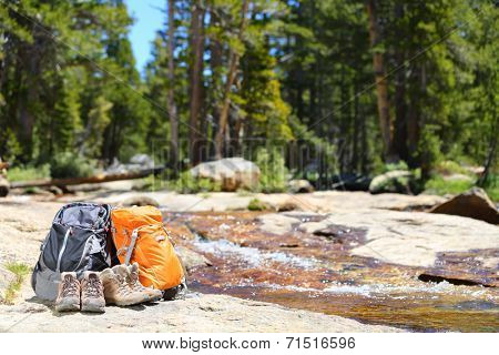 Hiking backpacks and hiker shoes. Hike concept of trekking hike gear equipment from couple on travel trip.