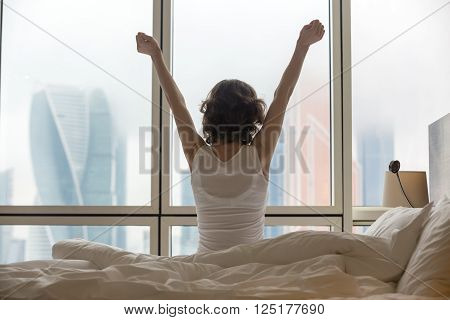 Young Woman Stretching After Waking Up