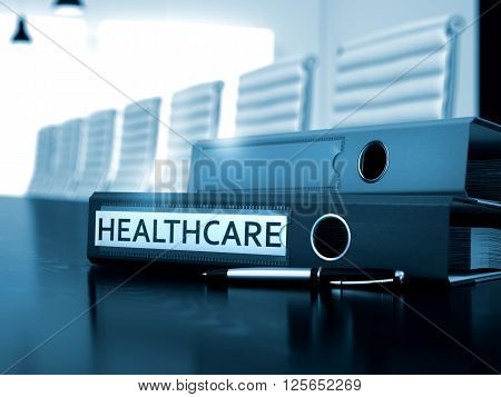 Healthcare. Illustration on Toned Background. Healthcare - Illustration. Healthcare - Ring Binder on Wooden Black Desktop. Healthcare - Business Concept on Blurred Background. 3D.