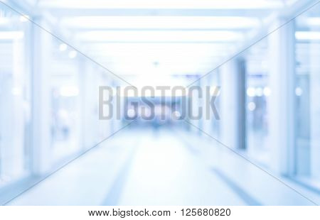 abstract defocused blurred background empty business corridor or shopping mall. Medical and hospital corridor defocused background with modern laboratory (clinic)