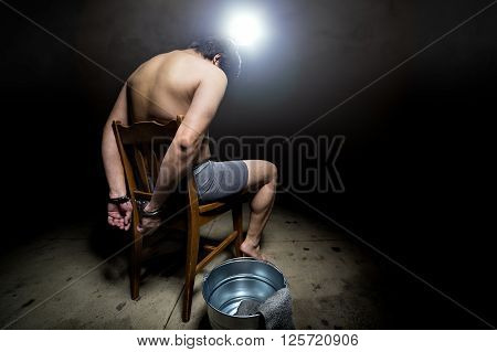 Prisoner being punished with cruel interrogation technique of waterboarding