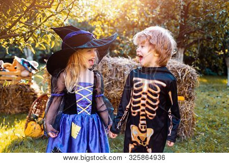 Children In America Celebrate Halloween. Happy Kids On Halloween Party. Trick-or-treating. Cute Chil