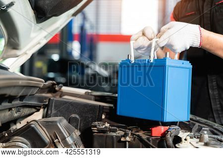 Close Up Hand Of Male Mechanic Changing Car Battery, Engineer Is Replacing Car Battery Because Car B