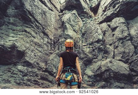 Climber Standing In Front Of A Rock