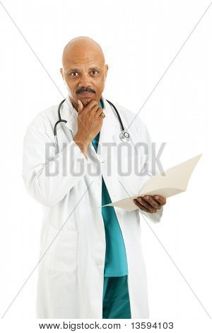 Serious african-american doctor considers treatment options while reviewing a patient's medical chart.  Isolated on white.