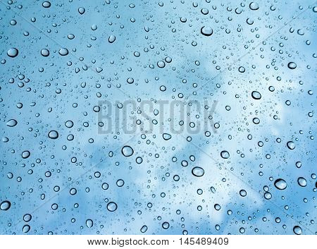 water drops on blue background / Drops of rain on glass , rain drops on clear window / Blue Abstract Water Drops Background / water drops on glass surface as background.