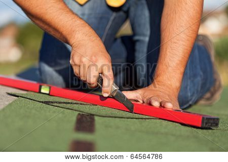 Worker Installing Bitumen Roof Shingles