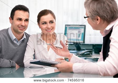 Cheerful young couple at financial planning consultation