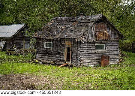 An Abandoned Wooden Old House, The Destruction Of Abandoned Houses After The Crisis, Desolation And 