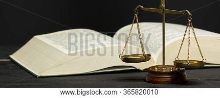 Law Concept - Open Law Book With A Wooden Judges Gavel On Table In A Courtroom Or Law Enforcement Of