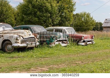 Mozhaisk, Russia - August 11, 2019: Old Abandoned Rusty Vehicles, Crushed Cars In Scrapyard, Junk Ya