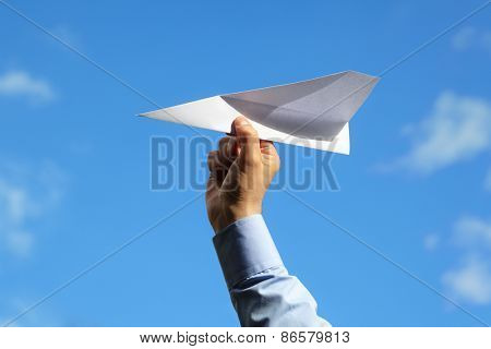 Businessman launching a paper airplane concept for business startup, entrepreneur, creativity and freedom