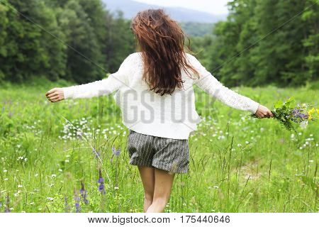 Happy pretty brunette woman in chamomile field cute female relaxed on flowers meadow spring nature having fun outdoor