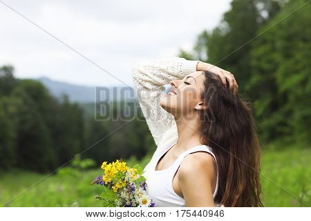 Happy pretty brunette woman in chamomile field cute female relaxed on flowers meadow spring nature having fun outdoor