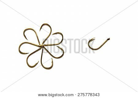 Fishing Hooks In Gold Color. Different Patterns Of Metal Fishing Hooks. Abstraction. Isolated.