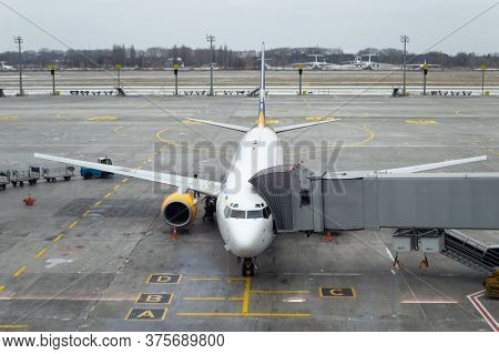 Plane With Jet Bridge Connected, Ready To Receive Passengers At The Airport. Air Plane At Parking Pl