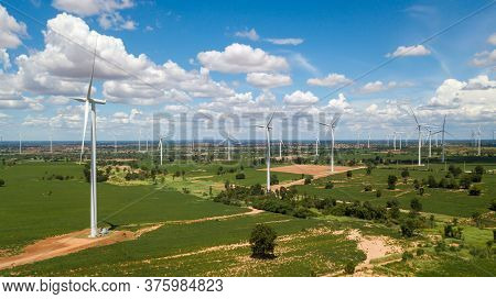 Aerial Landscape Of Windmills Farm With White Sky On Blue Sky At Huai Bong, Dan Khun Thot District, 