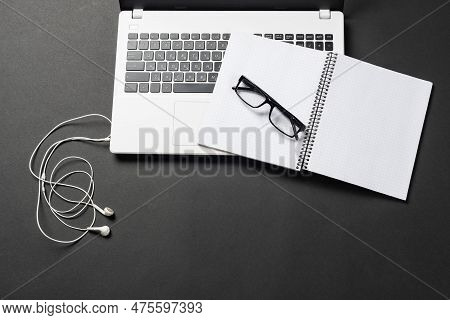 Still Life Of Office Workplace With Supplies And Copy Space. Flat Lay Black Surface With Laptop Comp