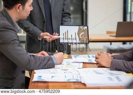 Asian Business Team Consists Of Marketing Staff. Accountant And Financial Officer Help Each Other An