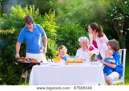 Big Happy Family Enjoying Bbq Grill In The Garden