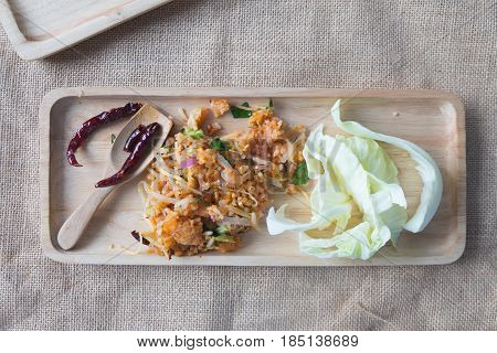 Yam Naem Khao Thot Recipe Spicy Salad of Curried Rice Croquettes Fermented Pork Ginger and Peanuts in wooden tray