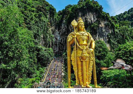 KUALA LUMPUR, MALAYSIA - OCTOBER 28, 2012: Golden statue at the entrance of the Batu Caves near Kuala Lumpur Malaysia