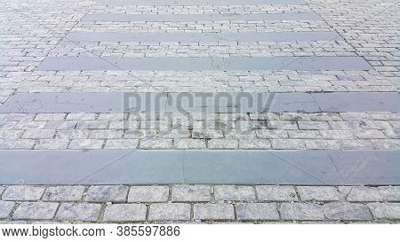 Pedestrian Crosswalk Made Of Stones. Cobblestone Walkway. Crosswalk On The Road For Safety When Peop