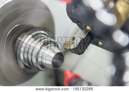 CNC lathe machine (Turning machine) cutting the metal screw thread part .Hi-precision CNC machining concept.