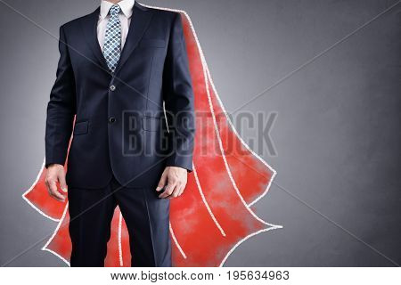 Superhero businessman with red cape drawing on background concept for leadership