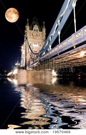 Tower Bridge, London at night reflected in the Thames