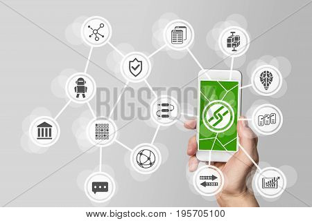 Blockchain and bitcoin concept with hand holding mobile phone