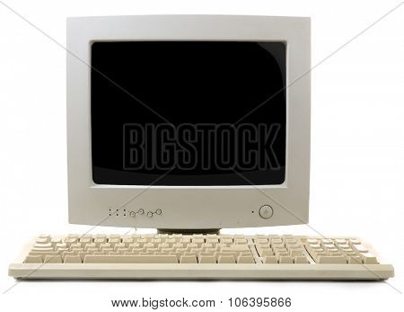 Old computer monitor and keyboard isolated on white