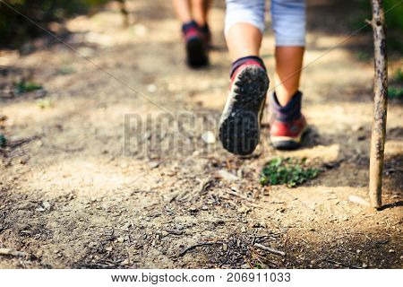 Children Hiking In Mountains Or Forest With Sport Hiking Shoes.