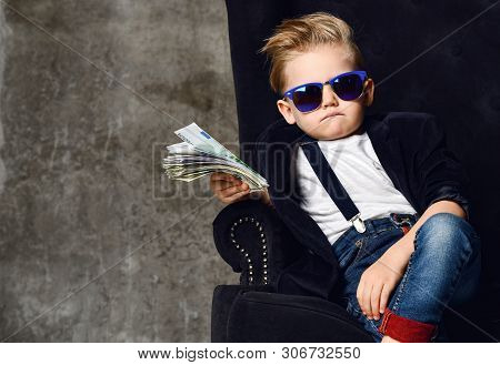 Happy And Shoutting Arrogant Rich Kid Boy Millionaire Sits With A Bundle Of Money Dollars Cash In Bi