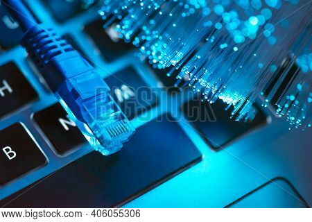 Internet Cable, Rj-45 Plug On Laptop Keyboard. High Speed Fiber Optic Internet Concept