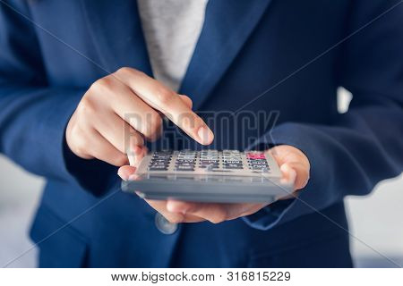 Close-up Of Business Accountant Financial Using Calculator For Estimated Tax Earning Account, Entrep