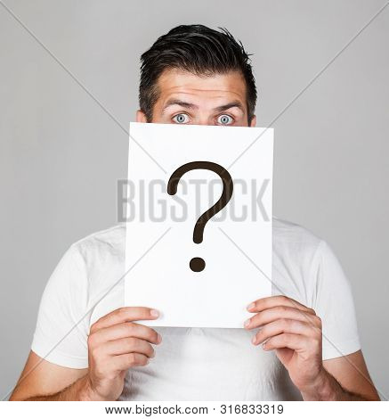 Question Mark, Symbol. Pensive Male. Man A Question. Doubtful Man Holding Question Mark. Problems An