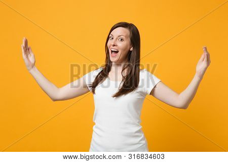 Portrait Of Cheerful Young Woman In White Casual Clothes Gesturing Demonstrating Size With Horizonta