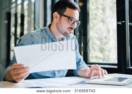 Serious Pensive Thoughtful Focused Young Casual Business Accountant Bookkeeper In Office Looking At 