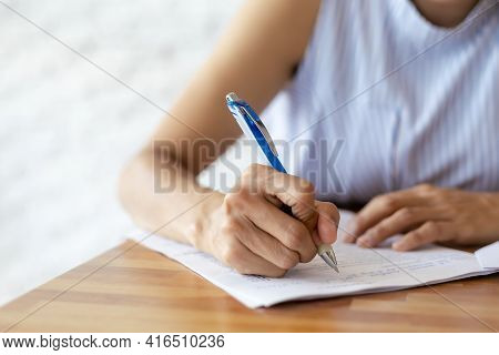 Close Up Hand Of Business Women Use Pen Writing Document Paper. Female Hand Close Up Writing With A 