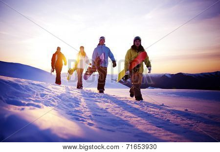 Group of snowboarders on top of the mountain.