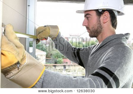 Worker with plasterboard