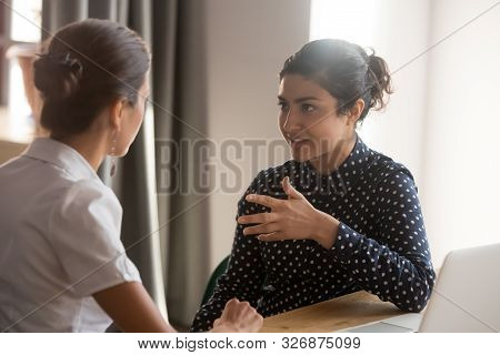 Serious Indian Mentor Worker Talk To Female Colleague Teach Intern