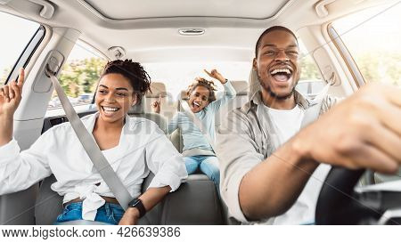 Happy Black Family Of Three Singing Having Fun Riding Car