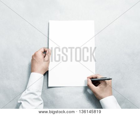 Hand holding blank agreement mockup and signing it. Arm in shirt hold clear document template mock up. Contract surface design. Simple pure legal paper print display. Reading contract statement.