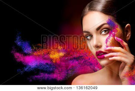 Fashion model girl portrait with colorful powder make up. Beauty woman with bright color makeup. Close-up of Vogue style lady face, Abstract colourful make-up, Art design. Black background