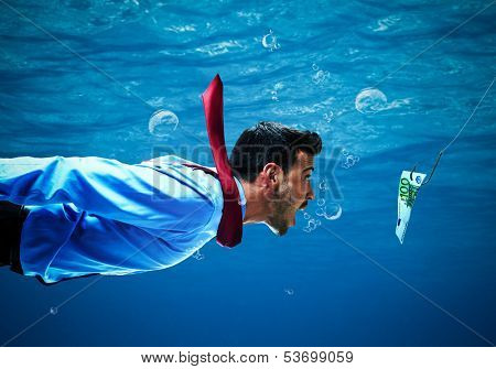 Underwater scene of a businessman taking the bait